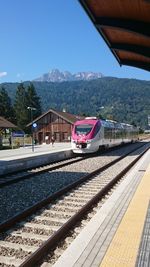 Train at railroad station against clear sky