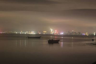 Boats in river at night