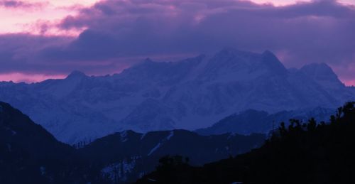 Scenic view of mountains against cloudy sky