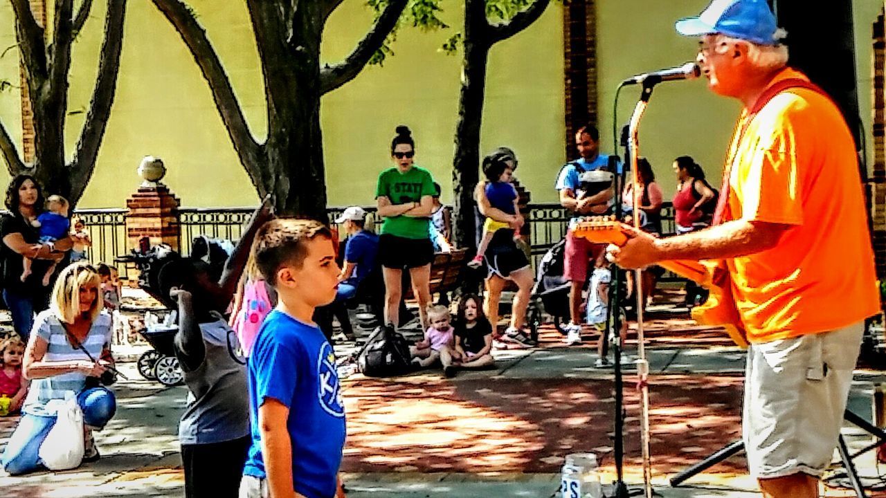 PEOPLE STANDING IN A ROW OF AN ANIMAL