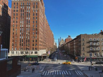 City street and buildings against sky