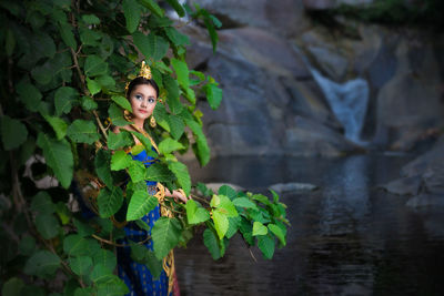 Portrait of young woman with leaves