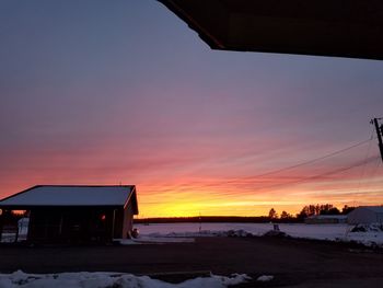 Snow covered landscape at sunset