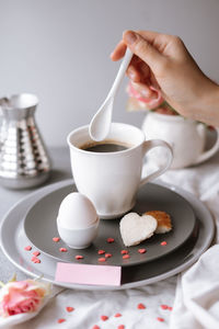 Midsection of person having breakfast on table