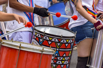 Midsection of man playing drum