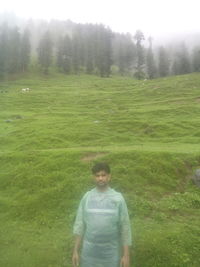 Portrait of man standing on grass