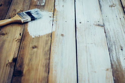 High angle view of paintbrushes on wooden table