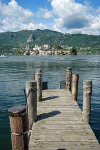 Wooden pier over lake against sky