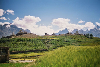 Distant view of temples on hill against sky