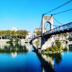 Bridge over river against blue sky