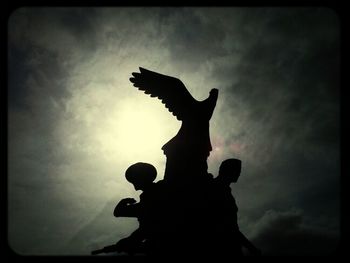 Low angle view of statue against cloudy sky