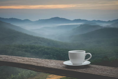 Coffee cup against mountains