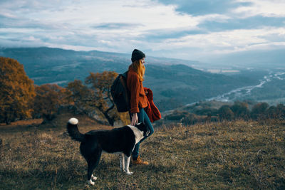 View of dog on landscape against mountains