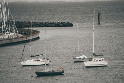 Boats sailing in sea against sky