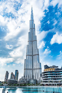 Low angle view of buildings against cloudy sky