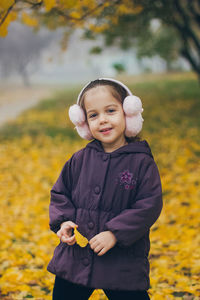 Portrait of cute girl standing on field