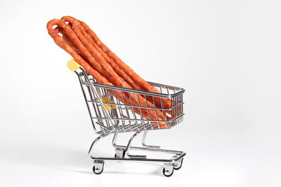 A kabanos in a supermarket cart at the white background. food products