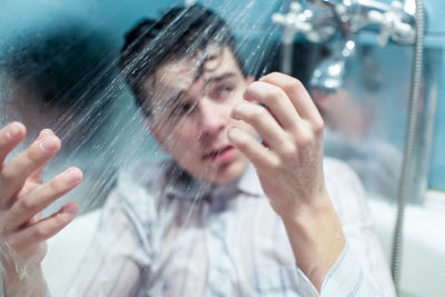 Depressed man taking shower