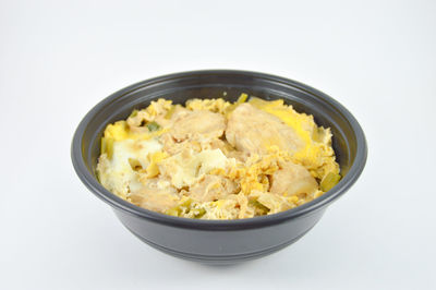 Close-up of pasta in bowl against white background