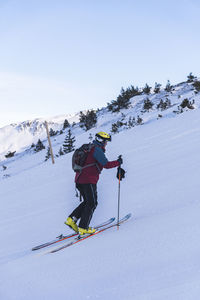 Full length of man skiing on snowcapped mountain