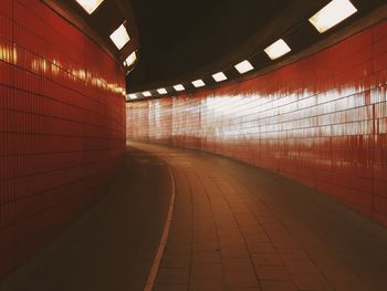 Empty road leading towards building