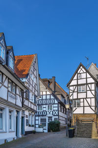 Buildings in town against clear blue sky