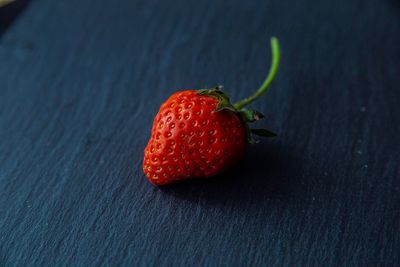 High angle view of strawberries on table against black background