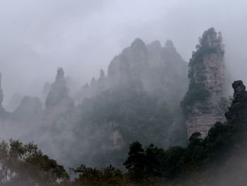 Panoramic view of trees and mountains against sky