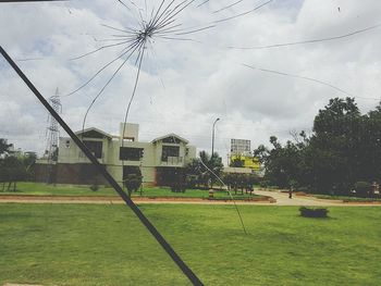 Houses on field against sky