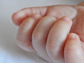 Close-up of baby's hand, newborn fingers in macro