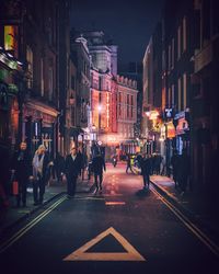 People walking on street at night