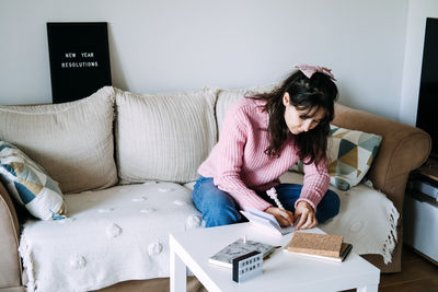 Portrait of woman using laptop at home