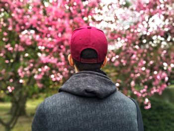 Man looking at cherry blossoms in garden