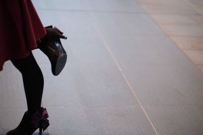 Low section of woman walking on street