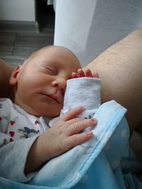Close-up of baby boy sleeping in hand