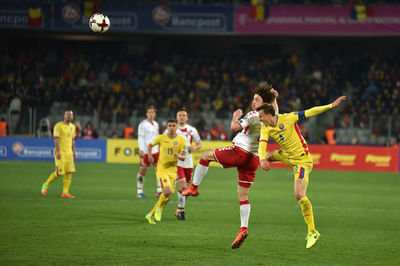 People playing soccer on field