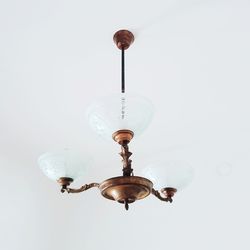 Low angle view of illuminated pendant light hanging on ceiling