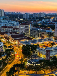 High angle view of illuminated street amidst buildings in city