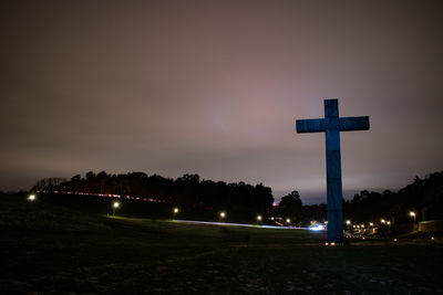 Cross against sky at night