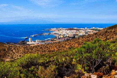 Scenic view of sea and townscape against sky