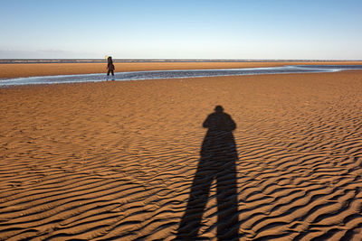 Shadow of man on beach