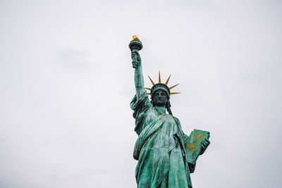 Low angle view of statue against sky