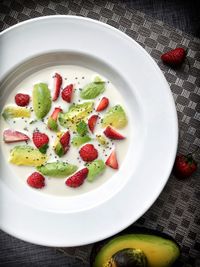 Avocado with fresh strawberries and almond milk