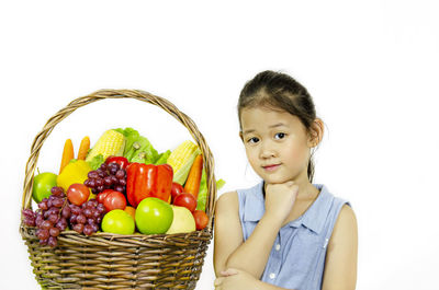 Portrait of woman holding fruits in basket