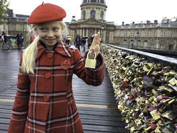 Portrait of young woman standing in city girl with locker as symbol of love . pont sea arts