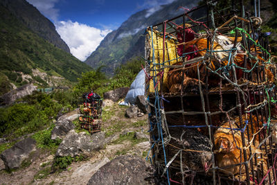 People on mountain road against cloudy sky