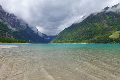 Scenic view of lake and mountains against sky