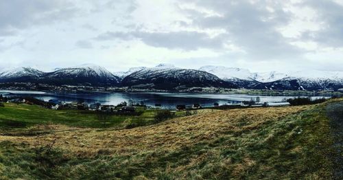 Scenic view of lake and mountains against sky