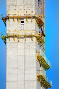 Low angle view of crane against sky