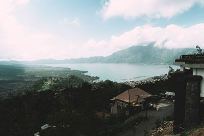 High angle view of townscape by sea against sky